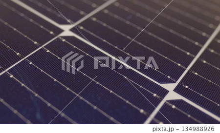 Macro shoot of modern photovoltaic solar battery panels. Ecology and environment protection concept. Renewable green energy. Solar panels close-up. Solar panels slow motion. Solar panels moving shot 134988926