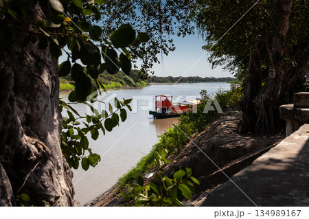 Non motorized ferry, called planchon, used by residents to cross the Sinu River from one bank to the other in the city of Monteria, Colombia. Non motorized ferry, called planchon, used by residents to cross the Sinu River from one bank to the other in the city of Monteria, Colombia. 134989167