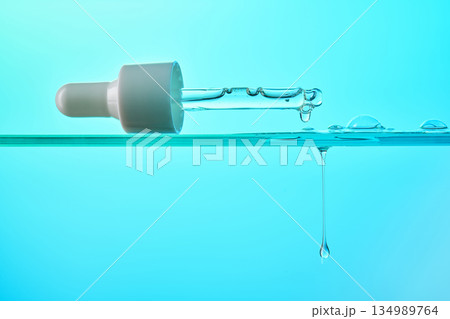 Pipette dripping serum liquid for skincare and hydration Pipette dripping serum liquid for skincare and hydration 134989764