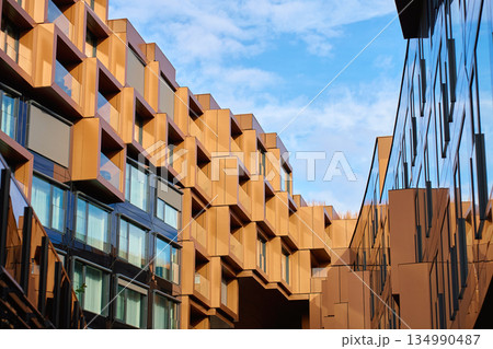 Modern building with geometric metal facade and glass elements 134990487