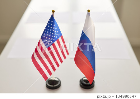US and Russia mini desk flags showcasing diplomacy on conference negotiation table US and Russia mini desk flags showcasing diplomacy on conference negotiation table 134990547