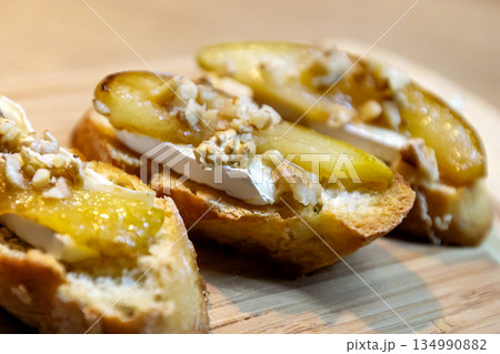 Pear bruschetta with white cheese and walnuts Pear bruschetta with white cheese and walnuts 134990882