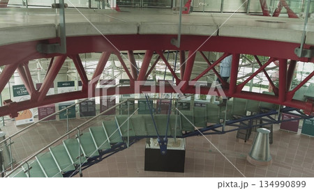 Office manager walking up on the stairs go to his cabinet in the upstairs the building. 134990899