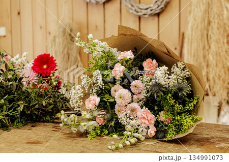 Florist arranging beautiful bouquet of pink and white flowers, Mothers day 134991073