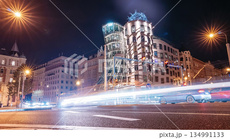 Night Traffic Near the Dancing House in Prague. City moving through illuminated streets 134991133