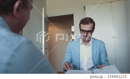 Two successful businessmen wear suits salesman banker manager handshake happy client customer investor at business meeting make bank loan insurance deal agreement shake hands sell Two successful businessmen wear suits salesman banker manager handshake happy client customer investor at business meeting make bank loan insurance deal agreement shake hands sell 134991225
