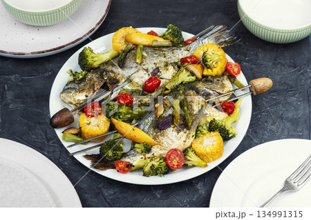 Grilled dorado fish with plums. 134991315