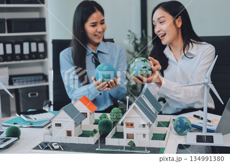 Hands of adult Asian business professionals analyzing ESG financial data and renewable energy project plans 134991380
