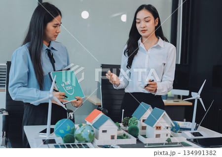 Hands of adult Asian business professionals analyzing ESG financial data and renewable energy project plans Hands of adult Asian business professionals analyzing ESG financial data and renewable energy project plans 134991382