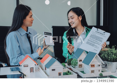 Professional real estate agents brainstorming house project while planning home investment with architectural model and documents Professional real estate agents brainstorming house project while planning home investment with architectural model and documents 134991390