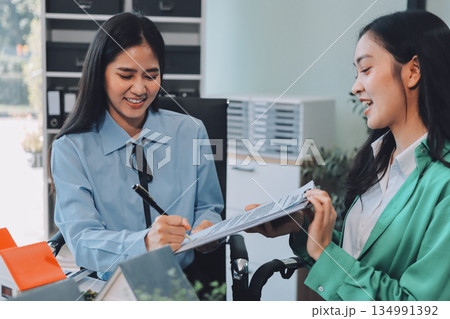 Professional real estate agents brainstorming house project while planning home investment with architectural model and documents Professional real estate agents brainstorming house project while planning home investment with architectural model and documents 134991392