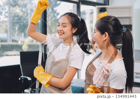 Cleaners clean empty office spaces Cleaners clean empty office spaces 134991443