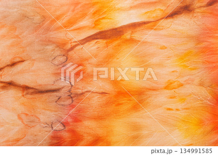 abstract pattern on silk fabric texture in yellow and brown tones abstract pattern on silk fabric texture in yellow and brown tones 134991585