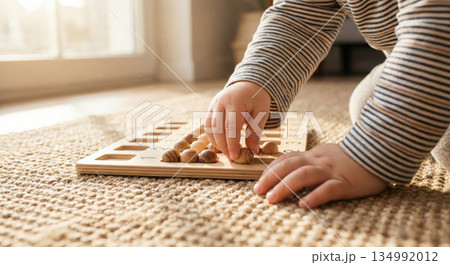 Child Plays With Wooden Plate 134992012