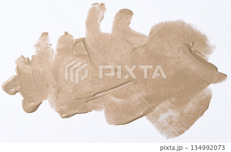 A broad brushstroke of nude or beige foundation with a distinct wave texture from the brush, glossy finish A broad brushstroke of nude or beige foundation with a distinct wave texture from the brush, glossy finish 134992073