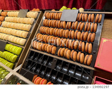 Colorful macarons displayed in a row on cafe counter 134992297