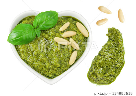 Pesto sauce in ceramic bowl isolated on white background. Top view. Flat lay. 134993619