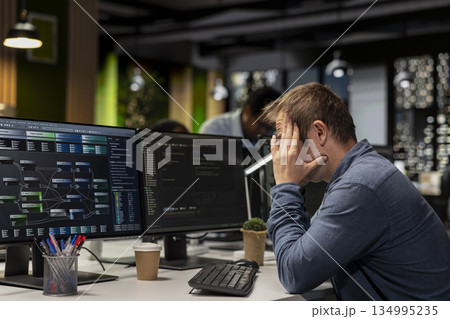 Dejected startup office engineer bummed by malfunctioning machine learning models enhancing automation. Sad Silicon Valley workplace IT expert concerned with broken AI assistant on computer Dejected startup office engineer bummed by malfunctioning machine learning models enhancing automation. Sad Silicon Valley workplace IT expert concerned with broken AI assistant on computer 134995235