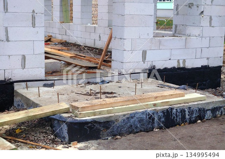 Preparing the porch of a house for pouring concrete Preparing the porch of a house for pouring concrete 134995494