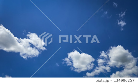 Vast blue sky filled with soft white clouds inspires calm, clarity, and a sense of freedom. Perfect for nature, travel, outdoor, wellness, and inspirational stock imagery. Vast blue sky filled with soft white clouds inspires calm, clarity, and a sense of freedom. Perfect for nature, travel, outdoor, wellness, and inspirational stock imagery. 134996257