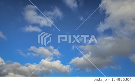 Vast blue sky filled with soft white clouds inspires calm, clarity, and a sense of freedom. Perfect for nature, travel, outdoor, wellness, and inspirational stock imagery Vast blue sky filled with soft white clouds inspires calm, clarity, and a sense of freedom. Perfect for nature, travel, outdoor, wellness, and inspirational stock imagery 134996304