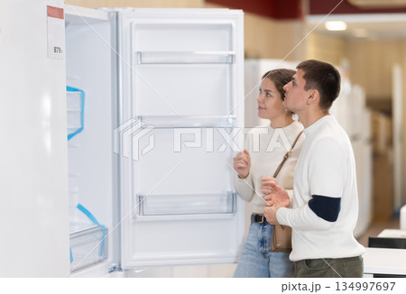 Couple choosing a refrigerator in an equipment store 134997697