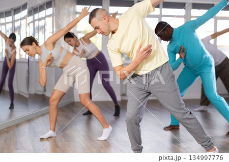 Young man learning modern street dancing during group class Young man learning modern street dancing during group class 134997776