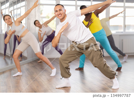 Expressive Asian guy honing hip-hop dance moves in studio Expressive Asian guy honing hip-hop dance moves in studio 134997787