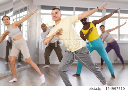 European guy with team of like-minded multinational people learn to elements of hip hop dance European guy with team of like-minded multinational people learn to elements of hip hop dance 134997810