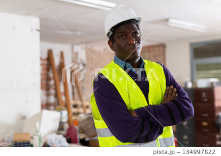 Confident african american engineer standing n building under renovation 134997822