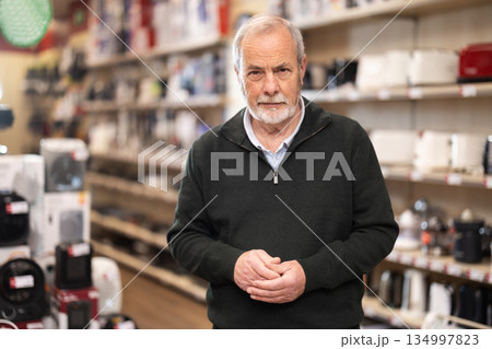 Elderly man choosing household appliances in the store 134997823