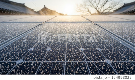 Traditional Korean palace courtyard covered in fresh snow with geometric stone patterns and classic hanok architecture at golden hour sunrise 134998025