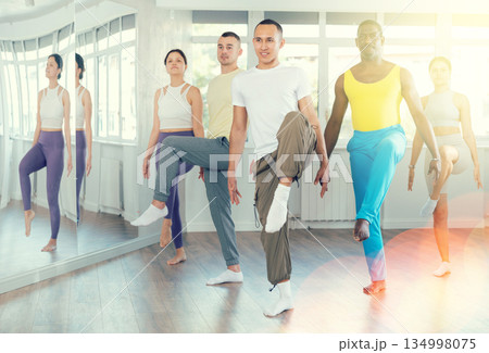 Young and middle-aged men and women practicing Irish dance in training hall Young and middle-aged men and women practicing Irish dance in training hall 134998075