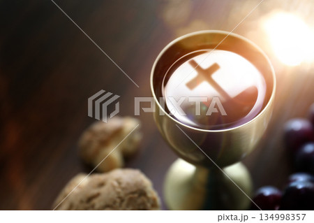 The Holy Communion bread and wine symbolizing the holy blood and body of Jesus Christ, the cross, and the Last Supper background 134998357