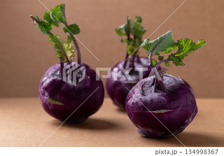 Purple kohlrabi or turnip cabbage on brown background Purple kohlrabi or turnip cabbage on brown background 134998367