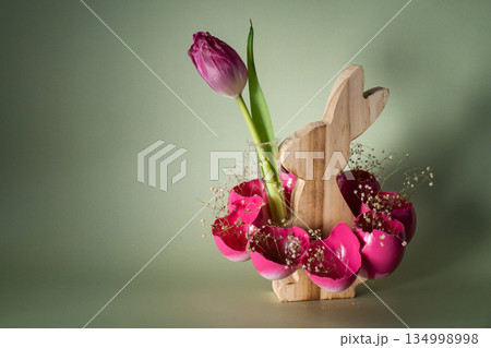 Self made vibrant pink egg shell with wooden bunny vase handmade decoration for Easter holiday. Copy space greeting card present gift ideas. Tulip flower Creative reuse zero waste sustainable living 134998998