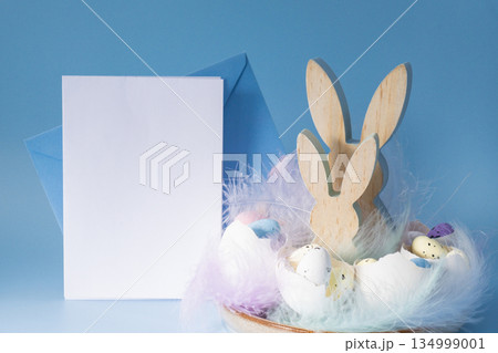 White empty paper note template mock up postcard Easter holiday decoration from sustainable materials egg shell wooden bunnies eggs decor. Copy space Diy do it yourself Gift present idea. Zero waste 134999001
