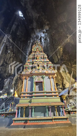 A vibrant Hindu temple bursts with color and sacred detail inside a cave 134999128