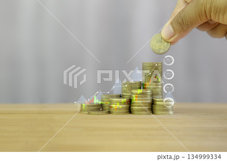 Stacked coins with bar and line graphs showing financial growth, investment, and saving concepts. Stacked coins with bar and line graphs showing financial growth, investment, and saving concepts. 134999334