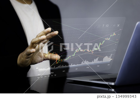 Businessman Analyzing Digital Stock Chart on Transparent Screen for Investment and Financial Growth Concept Businessman Analyzing Digital Stock Chart on Transparent Screen for Investment and Financial Growth Concept 134999343