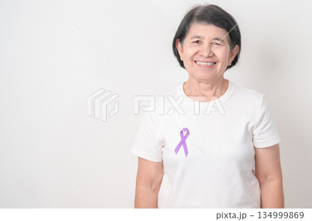 Elderly woman with light Purple Ribbon for All cancer, April Esophageal Cancer, January Thyroid disease, September Hodgkin Lymphoma, Awareness month and February World cancer day concepts Elderly woman with light Purple Ribbon for All cancer, April Esophageal Cancer, January Thyroid disease, September Hodgkin Lymphoma, Awareness month and February World cancer day concepts 134999869