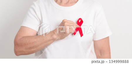 Elderly with Red Ribbon for December World Aids Day, MADD, October Red ribbon week, February Heart month, Marfan Syndrome, May Stroke awareness, March world TB Tuberculosis day and April Dare day 134999888