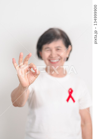 Elderly with Red Ribbon for December World Aids Day, MADD, October Red ribbon week, February Heart month, Marfan Syndrome, May Stroke awareness, March world TB Tuberculosis day and April Dare day 134999900