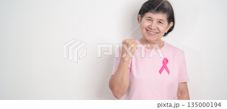 Elderly woman with pink Ribbon for Pink October Breast Cancer Awareness month, May Women Health, February World cancer day, support people life and illness. National cancer survivors month Elderly woman with pink Ribbon for Pink October Breast Cancer Awareness month, May Women Health, February World cancer day, support people life and illness. National cancer survivors month 135000194