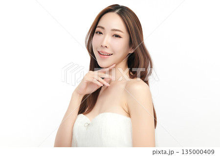 A beautiful young Asian woman with clean, fresh skin against a white background. Skincare, facial treatment, cosmetology, beauty, and spa. An elegant portrait of an Asian woman. A beautiful young Asian woman with clean, fresh skin against a white background. Skincare, facial treatment, cosmetology, beauty, and spa. An elegant portrait of an Asian woman. 135000409
