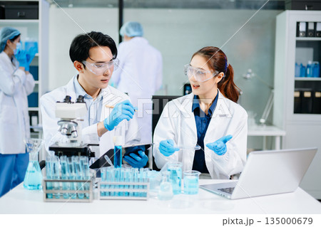 Scientists conducting medical research in a bright lab with microscopes and samples, representing healthcare innovation Scientists conducting medical research in a bright lab with microscopes and samples, representing healthcare innovation 135000679