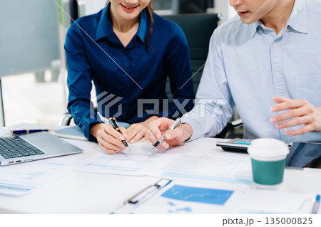 Businessman and team analyzing financial statement Finance task. with smart phone and laptop and tablet. Wealth management concept. 135000825