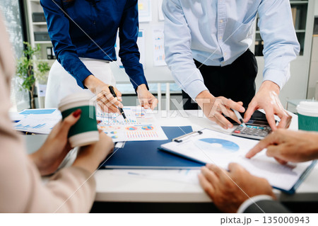 Businessman and team analyzing financial statement Finance task. with smart phone and laptop and tablet. Businessman and team analyzing financial statement Finance task. with smart phone and laptop and tablet. 135000943