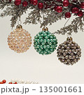 Handmade beaded Christmas balls hanging on festive tree 135001661