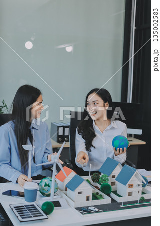 Hands of adult Asian business professionals analyzing ESG financial data and renewable energy project plans Hands of adult Asian business professionals analyzing ESG financial data and renewable energy project plans 135002583